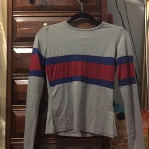A grey long sleeve with blue and red.